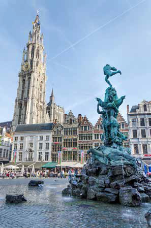 Tourists visit The Grand Place with the Statue of Brabo