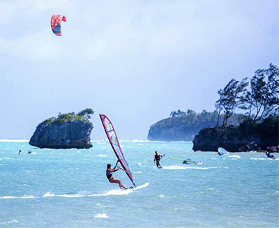 Windsurfers and kiteboarders enjoying wind power on Bulabog Beach