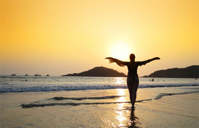 Young woman meditating on Agonda Beach