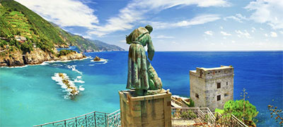 Monterosso al Mare, Cinque Terre, view of the bay with bronze sculpture of a monk