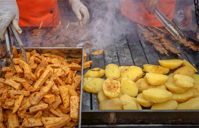 Preparing seasoned beef heart anticuchos in Lima