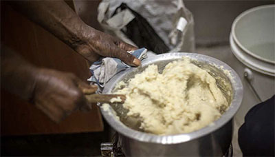 Woman preparing ugali