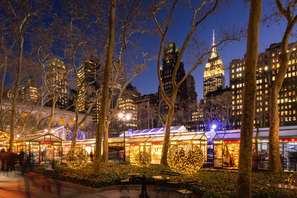 NYC Bryant Park Winter Village Christmas Market in evening with the